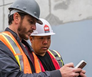 Contractors Using Digital Software on Construction Site